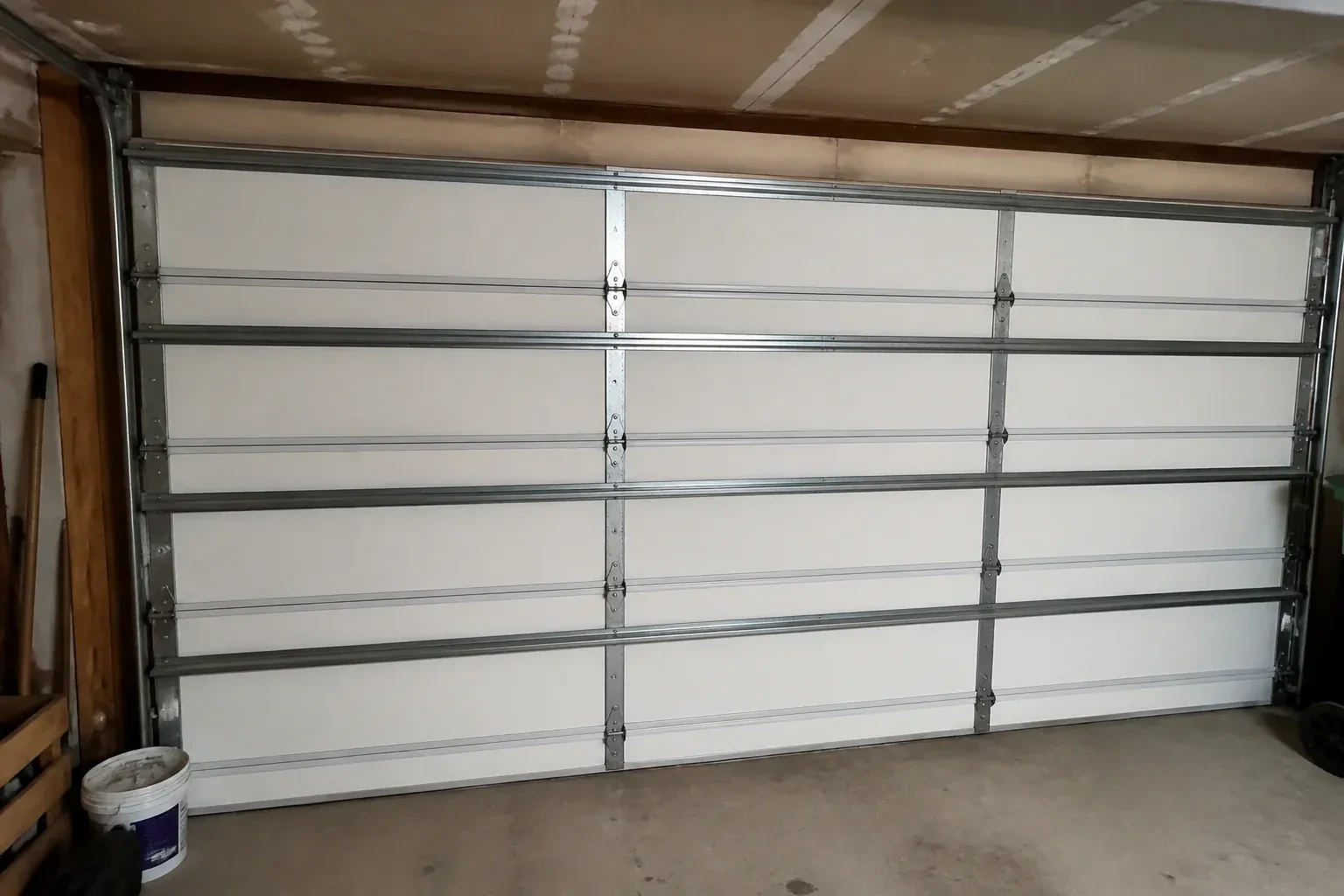 Interior of a closed sectional door with horizontal metal reinforcement struts. — Wind-Rated Garage Door Replacement, Niagara Falls